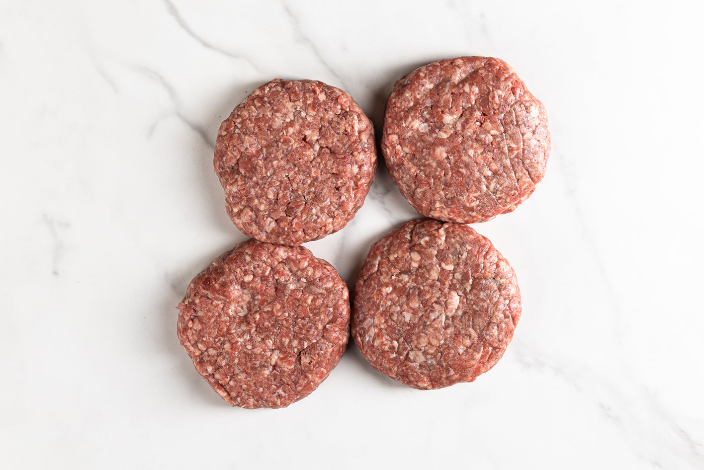 4 burgers on marble background