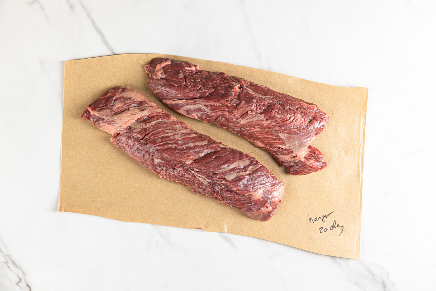Two hanger steaks on butcher paper