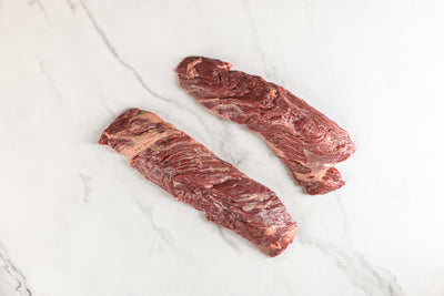 Two hanger steaks on marble background